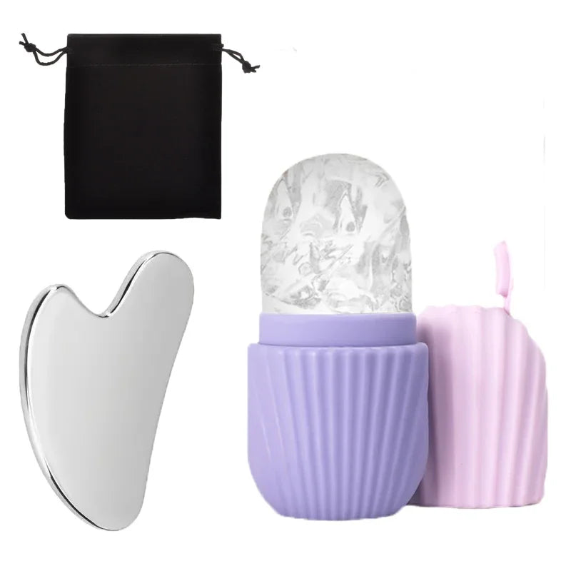 Set of skincare tools including a silver gua sha tool, a ice face roller, and two purple containers on a white background.